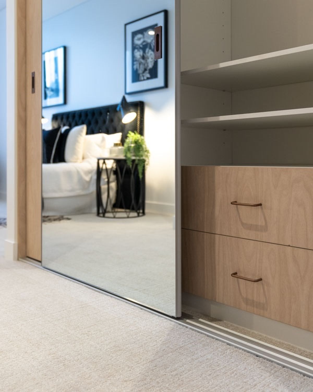 Frameless sliding mirror door on Portsea built-in wardrobe with inbuilt shelves and drawers