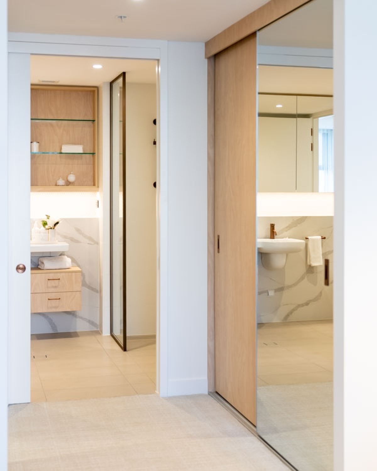 Waterford built-in wardrobe with one mirrored sliding door complimenting one timber door