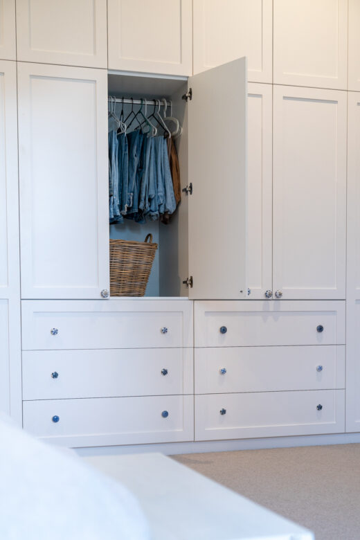 Master bedroom wardrobe in Dulux Natural White 2-pack finish, featuring custom-designed cabinetry for a high-end, built-in storage solution by Packers.