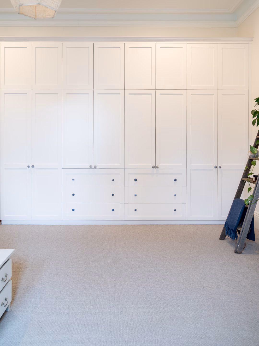 Two-panel Boston wardrobe with exposed drawers in Solver Paper White 2-pack satin finish, featuring custom handles supplied by the client and manufactured by Packers.