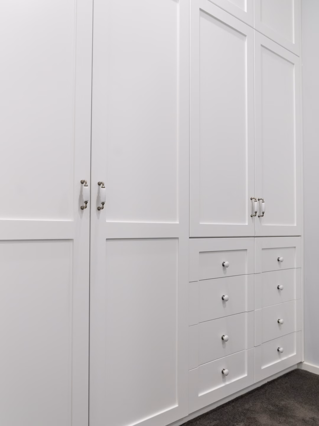 Two-panel Boston wardrobe with exposed drawers in Dulux Vivid White 2-pack satin finish, featuring custom-built cabinetry by Packers.