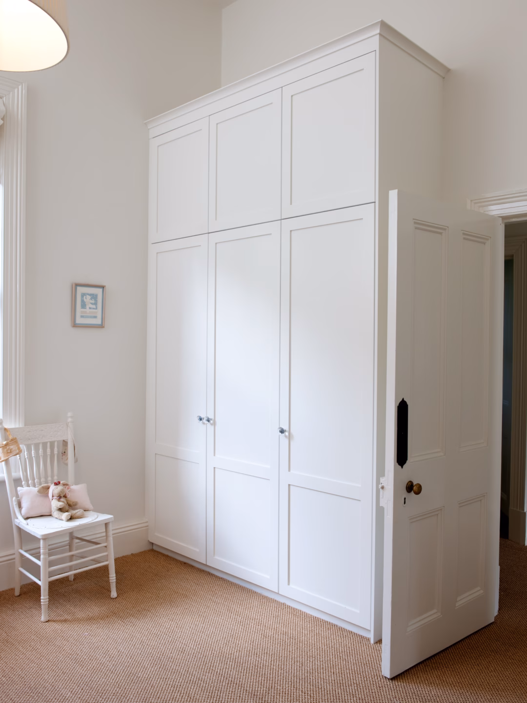 Two-panel Boston wardrobe in Dulux Vivid White 2-pack satin finish, featuring a custom scotia cornice and built-in design by Packers.