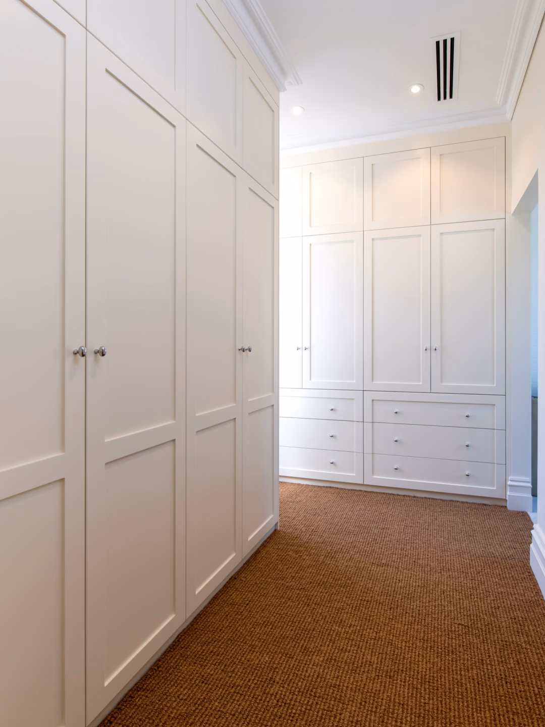 Master dressing room floor-to-ceiling Boston wardrobe with 2-panel doors and exposed drawers in Dulux Stowe White 2-pack satin finish by Packers.