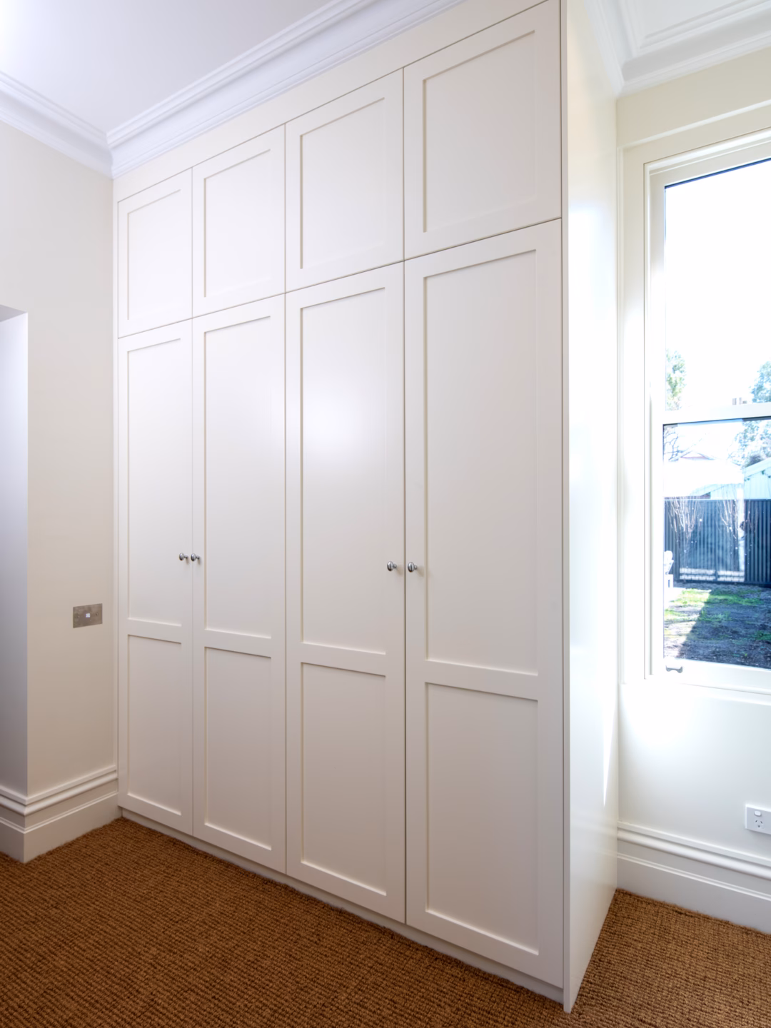 Floor-to-ceiling 2-panel Boston wardrobe in Dulux Stowe White 2-pack satin finish, featuring custom-built hinged doors by Packers.