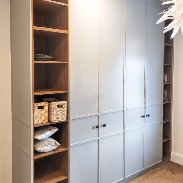 Custom 3-panel Boston slimline hinged wardrobe in Dulux Flooded Gum 2-pack satin finish, featuring Polytec Notaio Walnut internal shelving and Lo & Co Ascot black knobs.