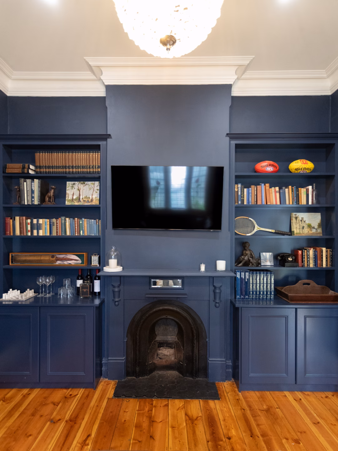 Traditional built-in Oxford wardrobes and open shelving in Porter's Yacht Race 2-pack satin finish, featuring a colonial cornice and integrated fireplace design by Packers.