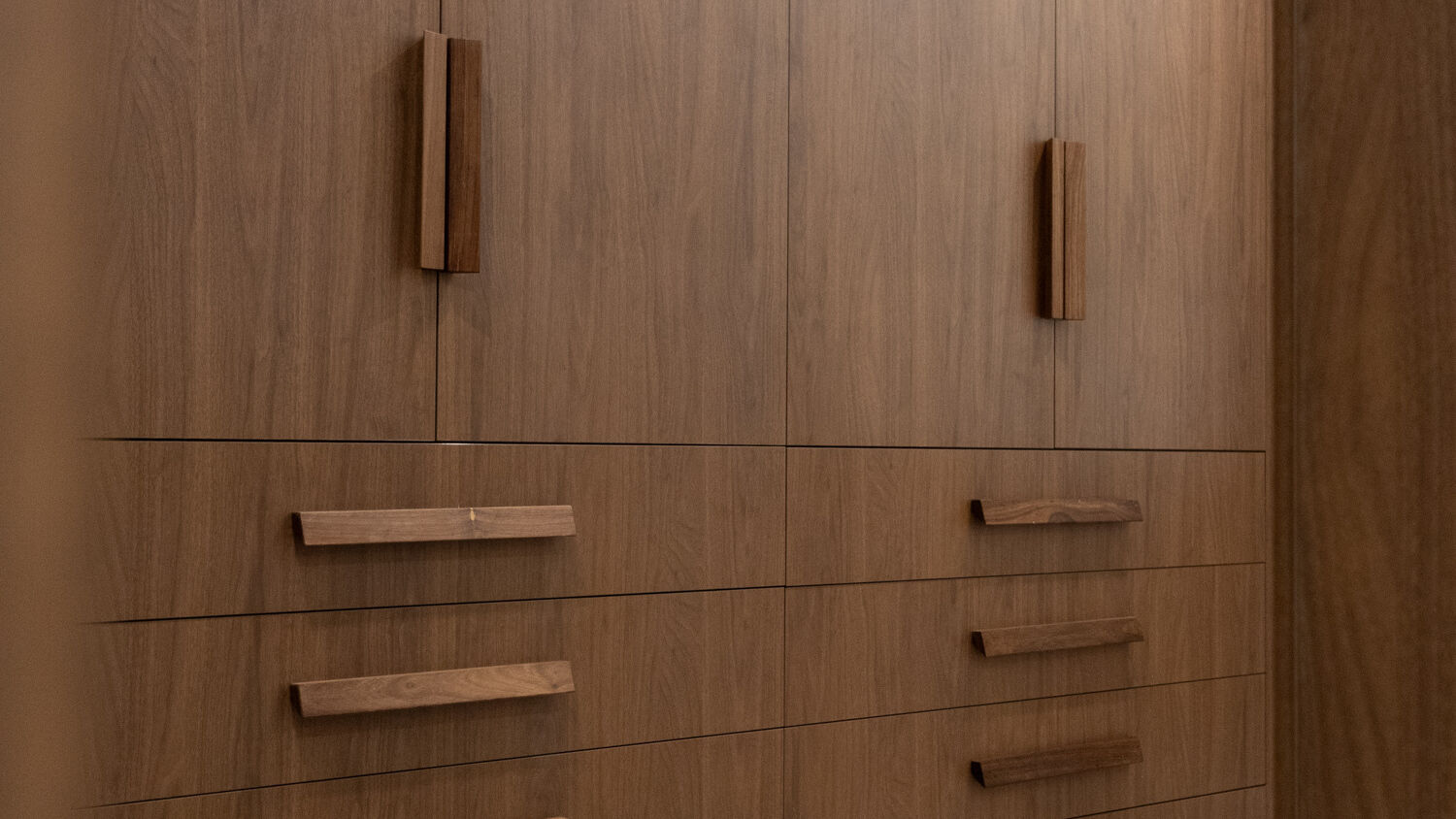 Bespoke Sorrento hallway dressing room in Polytec Florentine Walnut Woodmatt with exposed drawers and custom diamond timber handles, designed and manufactured by Packers.