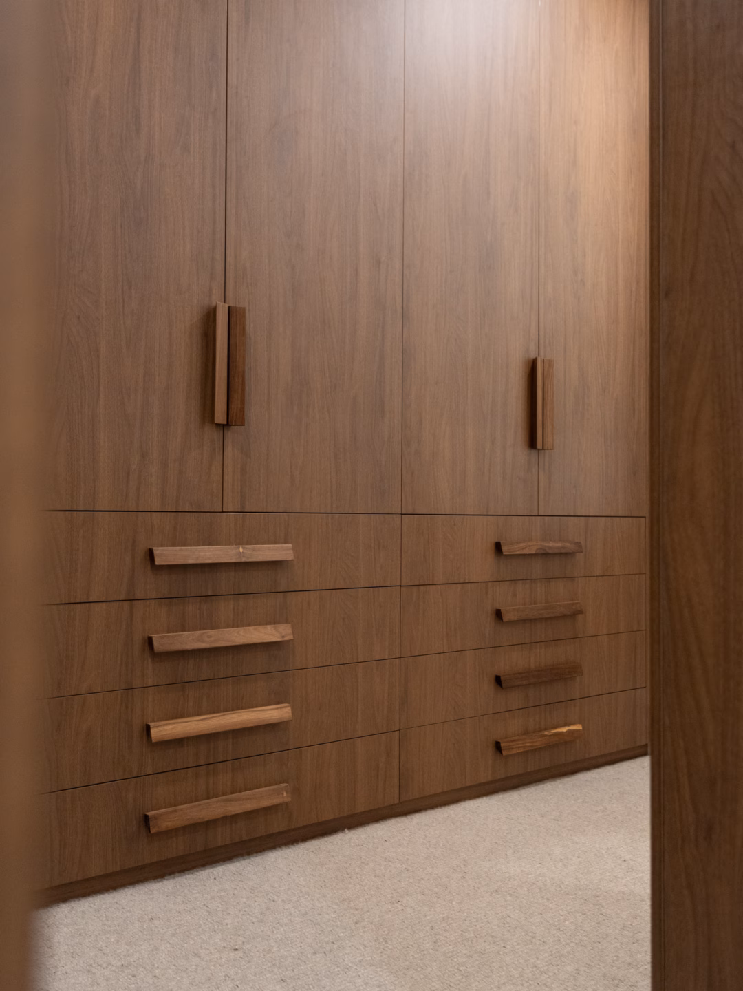 Bespoke Sorrento hallway dressing room in Polytec Florentine Walnut Woodmatt with exposed drawers and custom diamond timber handles, designed and manufactured by Packers.