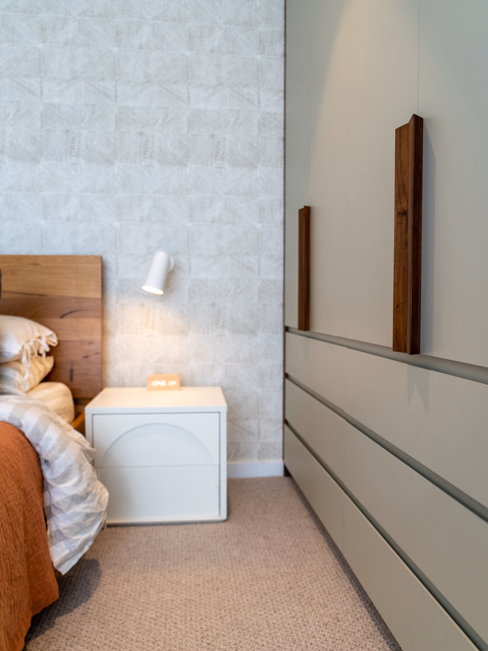 Modern Sorrento flush panel wardrobe featuring custom diamond timber handles and exposed bevel edge drawers, designed with a minimalist aesthetic by Packers.