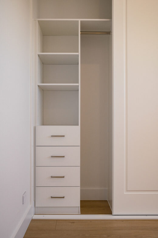 Halifax sliding wardrobe storage featuring a classic drawer unit with brushed nickel hardware, custom-organised by Packers.