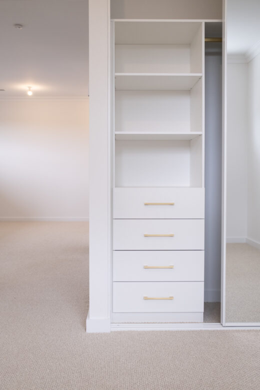 Halifax sliding wardrobe configuration featuring a standard drawer unit and slimline white frames, custom-engineered for organised storage by Packers