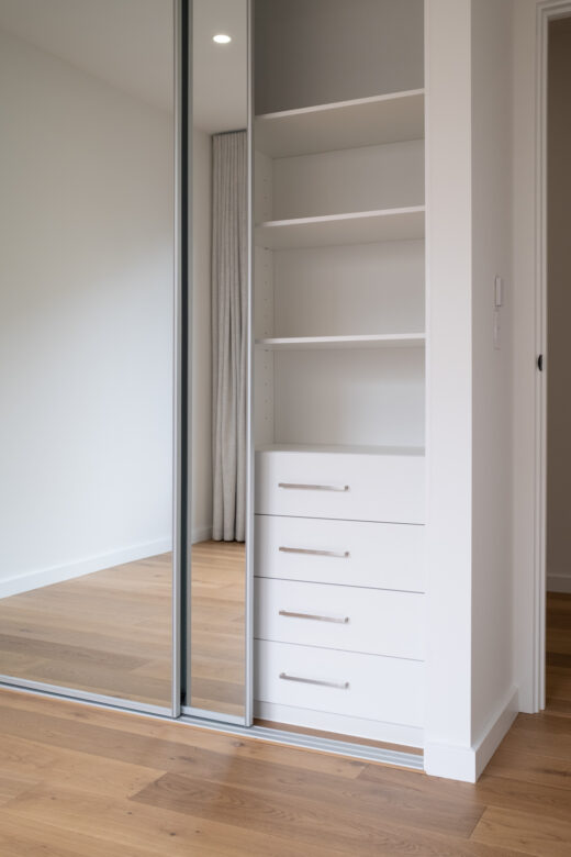 Halifax sliding wardrobe featuring full-length mirror doors with matt natural frames and an internal Alto drawer unit with brushed nickel hardware by Packers.