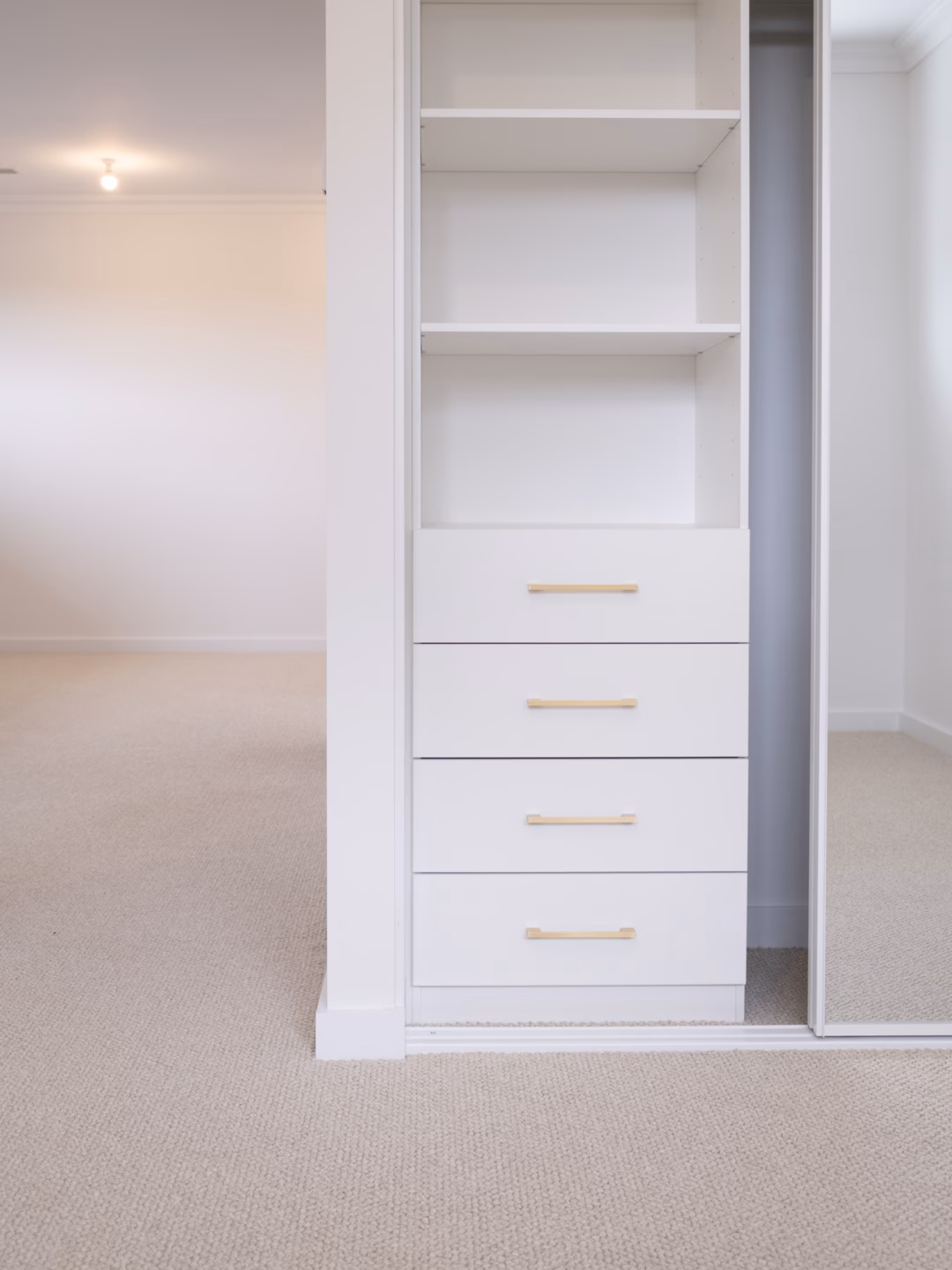 Halifax sliding wardrobe configuration featuring a standard drawer unit and slimline white frames, custom-engineered for organised storage by Packers