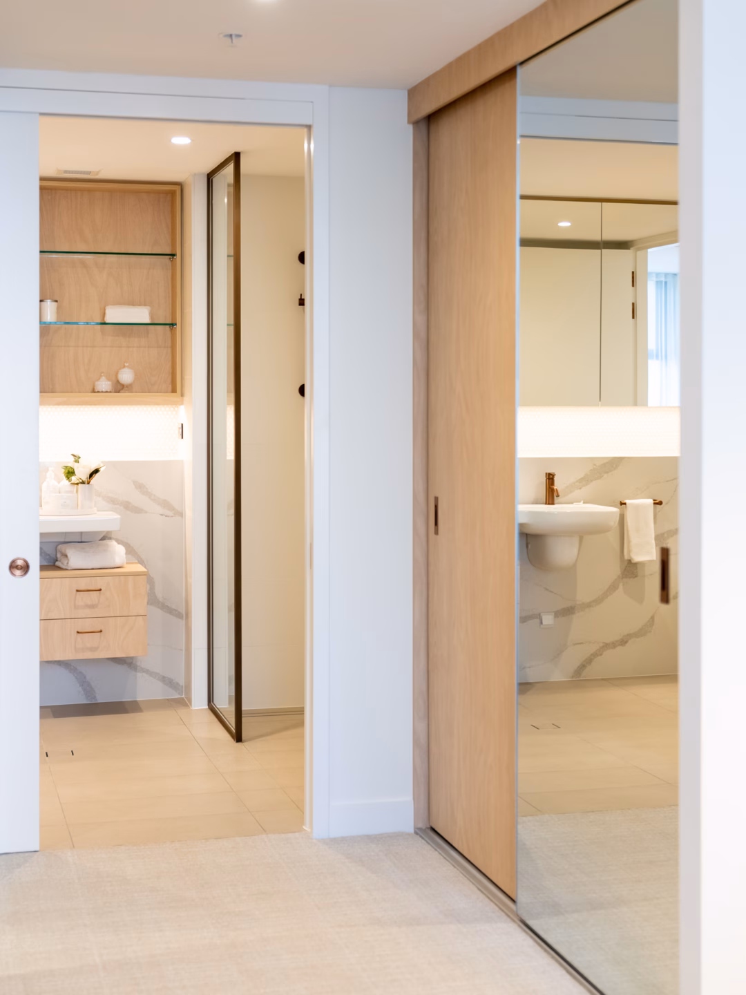 Custom wardrobe featuring a Waterford and Portsea combination with frameless mirrored doors and integrated storage, precision-installed by Packers.