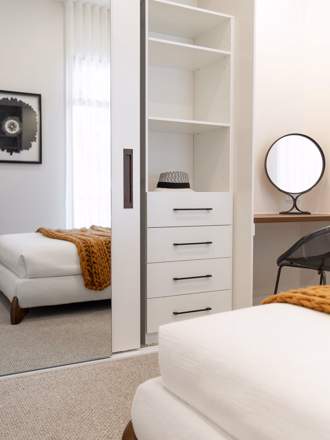 Bespoke bedroom joinery featuring a three-door wardrobe with a Portsea frameless mirror and Waterford framed door, integrated with a matching study desk and internal soft-close drawers by Packers.