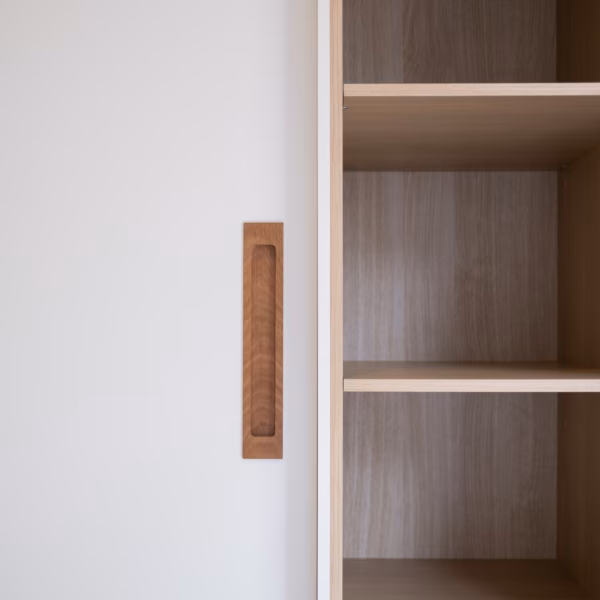 Custom Waterford wardrobe featuring American White Oak recessed timber handles and integrated open shelving, precision-crafted for a modern, functional bedroom design by Packers