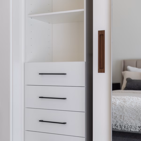 Bespoke two-door wardrobe combining a Waterford framed door and a Portsea frameless mirrored door, featuring internal soft-close drawers and a recessed Spotted Gum timber handle by Packers.