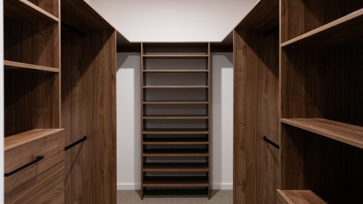 U-shaped standard walk-in robe in Polytec Notaio Walnut Matt featuring dual custom drawer units and adjustable shelving for versatile storage, by Packers.