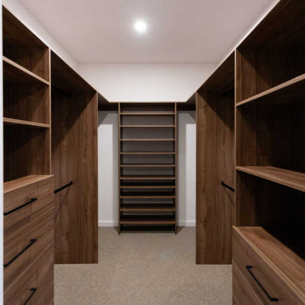 U-shaped standard walk-in robe in Polytec Notaio Walnut Matt featuring dual custom drawer units and adjustable shelving for versatile storage, by Packers.