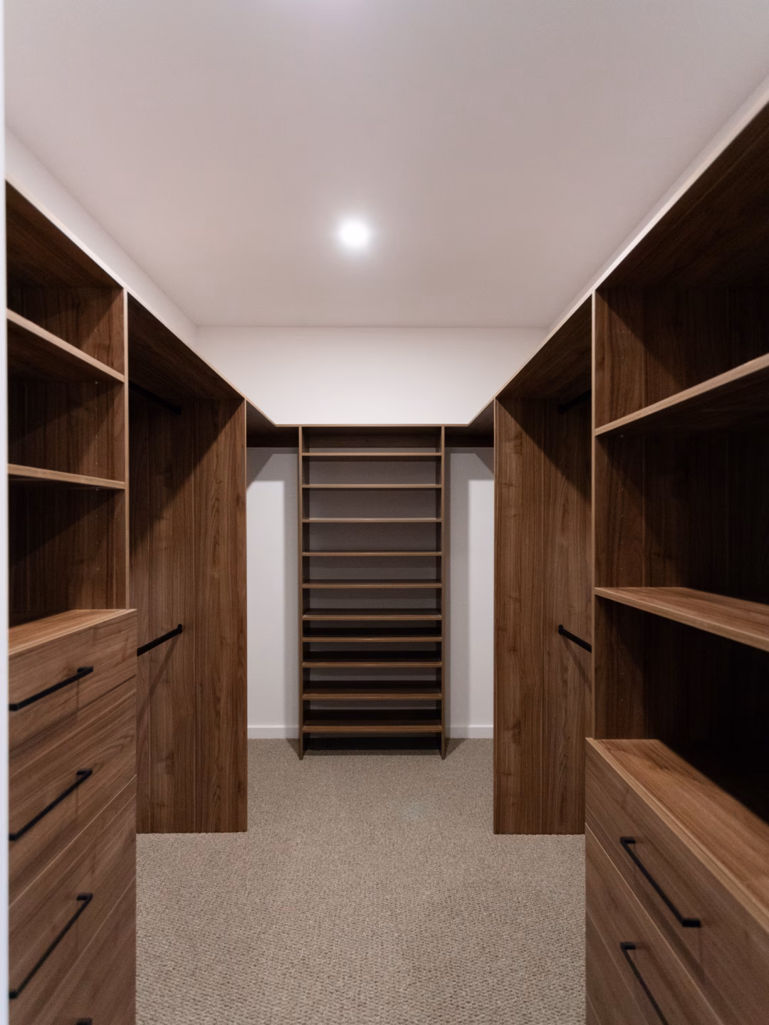 U-shaped standard walk-in robe in Polytec Notaio Walnut Matt featuring dual custom drawer units and adjustable shelving for versatile storage, by Packers.