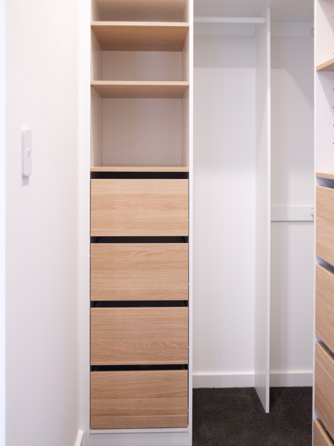 Standard walk-in robe featuring narrow Alto inset drawer units in a two-tone Polytec Polar White Matt and Natural Oak Matt finish, custom-built by Packers.