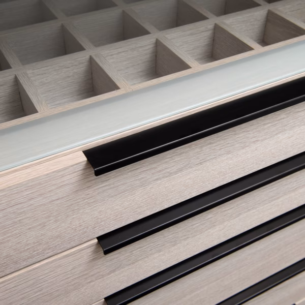 Semi-carcass walk-in robe featuring an etched glass top drawer unit with an integrated jewellery grid box and Artia Black Jay handles, custom-designed by Packers.