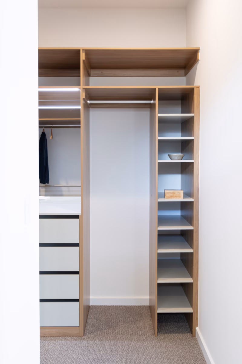 Custom-built walk-in robe featuring Polytec Prime Oak and Verdelho Smooth internals, including an adjustable shoe shelf tower and long hanging section at 2100mm high, by Packers.
