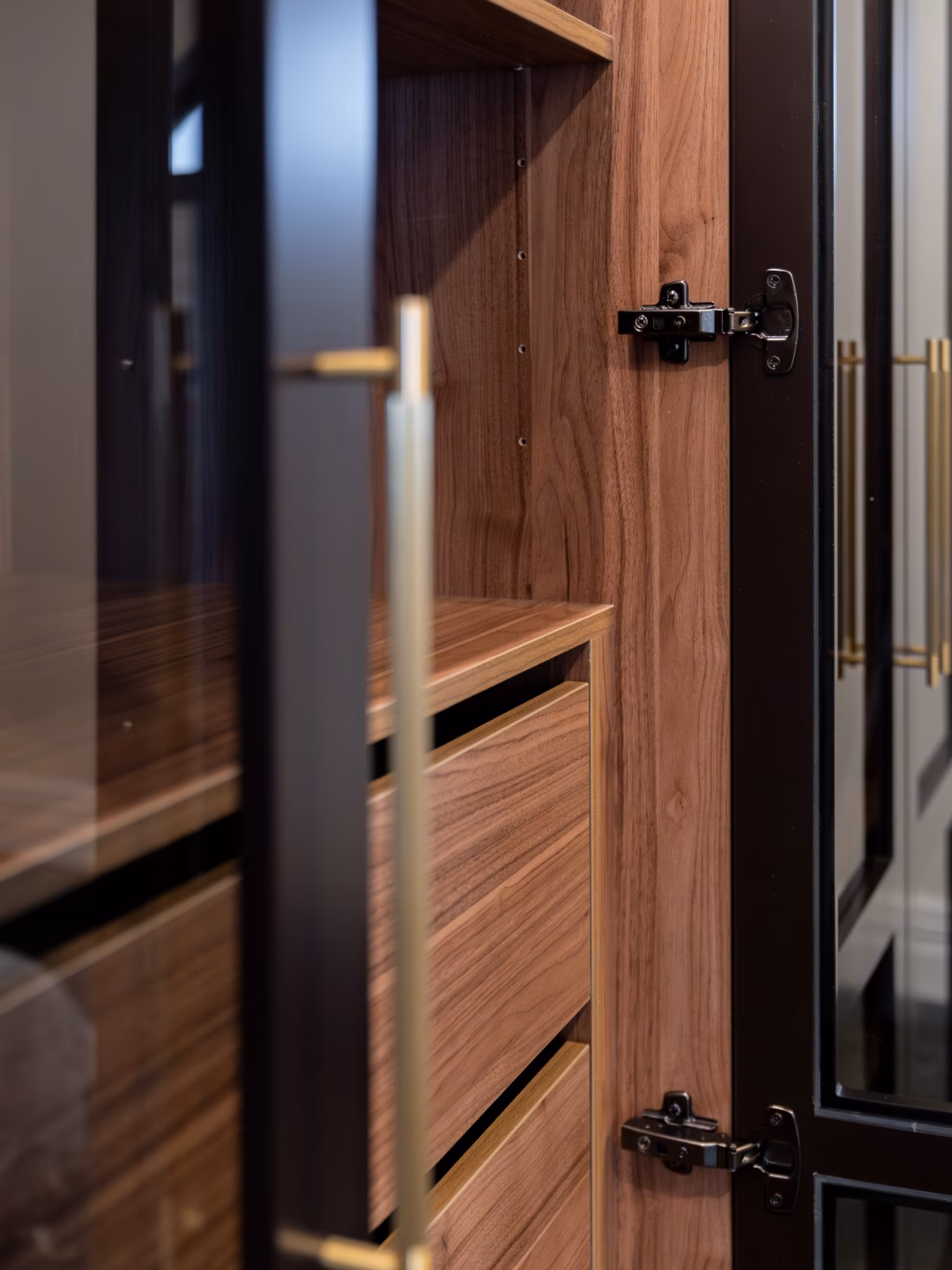 Bespoke Boston wardrobe doors with glass inserts and Polytec Notaio Walnut Matt internals, featuring a custom-designed storage layout by Packers.