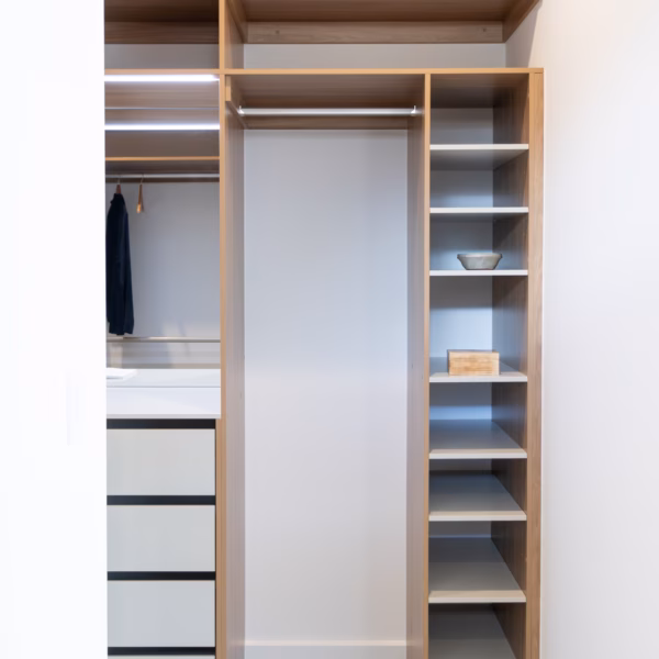Custom-built walk-in robe featuring Polytec Prime Oak and Verdelho Smooth internals, including an adjustable shoe shelf tower and long hanging section at 2100mm high, by Packers.